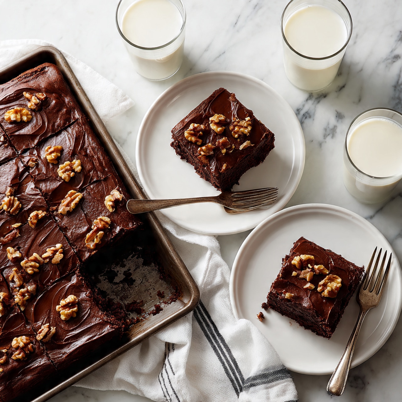 A large tray filled with a shiny, dark chocolate cake that has a thick layer of chocolate frosting with walnut pieces spread evenly on top. Next to the tray, there are three white plates each holding a square piece of the same chocolate cake with visible walnut bits in the frosting, one plate has two silver forks resting beside the cake. Around the plates, there are three tall glasses filled with milk. The setup is on a white marbled surface with a white cloth with black stripes partially under the tray. One piece of cake has a small bite taken out of it, showing a moist, dark brown inside. photo taken with an iphone --ar 4:5 --v 7