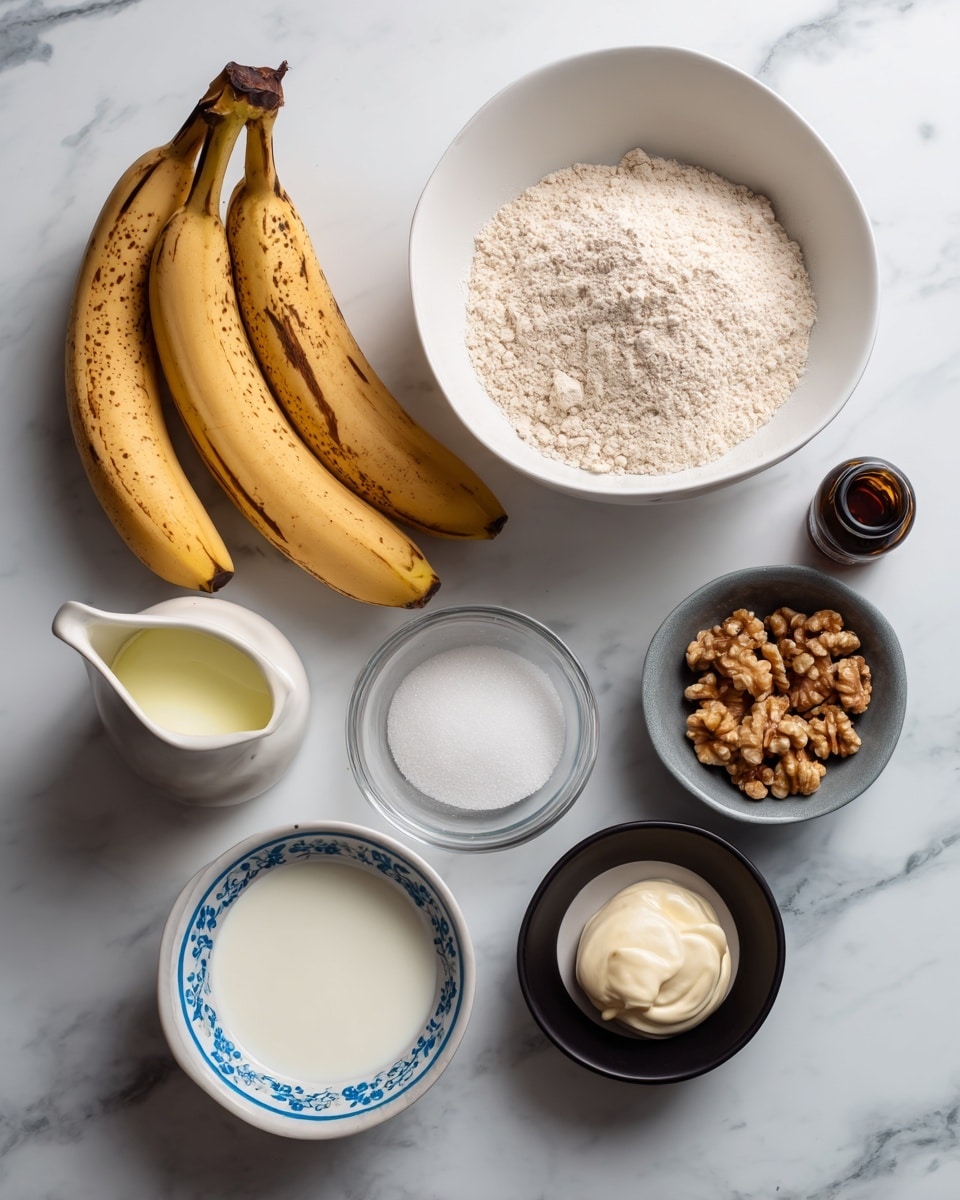 The image shows a collection of ingredients placed on a white marbled surface. At the top center, there is a white bowl filled with a mound of dry flour mixed with other dry ingredients. To the left of the bowl, three ripe brown-spotted bananas are arranged vertically. Below the bananas, there is a clear glass bowl filled with white sugar granules. Toward the middle, there is a small dark gray container holding light yellow oil, positioned near a white small pitcher of milk placed slightly to the left. On the bottom right, a white bowl with a blue floral inner pattern contains walnut pieces. Adjacent to it on the right side is a small black bowl with a dollop of smooth mayonnaise. Above the mayonnaise container, to the right of the dry ingredient bowl, stands a small dark bottle of vanilla extract. The overall setup is neat and well spaced. photo taken with an iphone --ar 4:5 --v 7