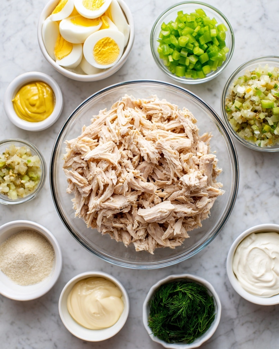A large clear glass bowl filled with shredded cooked chicken, light brown and slightly moist in texture, sits slightly off center at the top on a white marbled surface. Surrounding this bowl are eight smaller white bowls and clear glass bowls arranged closely in a semi-circle. From the top right clockwise, the first bowl contains chopped hard-boiled eggs with white and bright yellow pieces; the second has chopped bright green celery; the third holds chopped dark green scallions; the fourth has a yellow sauce labeled yellow mustard in a small white bowl; the fifth is filled with a pale greenish-yellow sweet relish with visible small chunks; the sixth has powdery light beige garlic powder in a small white bowl; the seventh bowl contains fresh, fine dill leaves in bright green; and the eighth bowl is filled with thick white sour cream. Near the bottom left is another white bowl containing creamy pale yellow mayonnaise. photo taken with an iphone --ar 4:5 --v 7