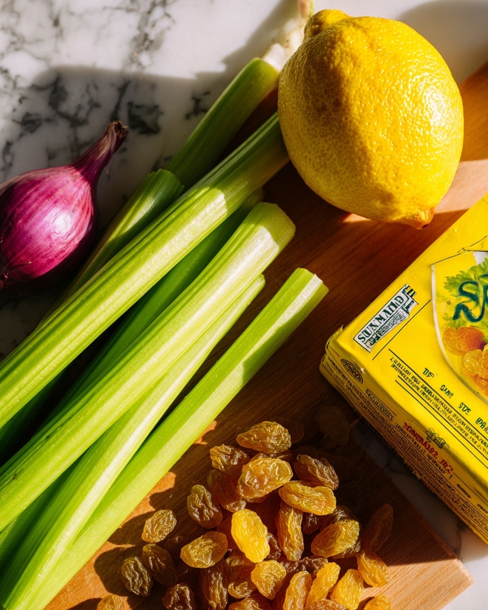 The image shows a wooden cutting board on a white marbled surface with a bright yellow box of Sun-Maid golden raisins in the bottom right corner. To the left of the box, there are bright green celery stalks with crisp, ribbed textures lying flat, some extending off the board. Above the celery, a small purple shallot with smooth, slightly shiny skin rests next to a large, vibrant yellow lemon with a textured peel. The items are arranged closely together, showing fresh and colorful ingredients with natural lighting. Photo taken with an iphone --ar 4:5 --v 7