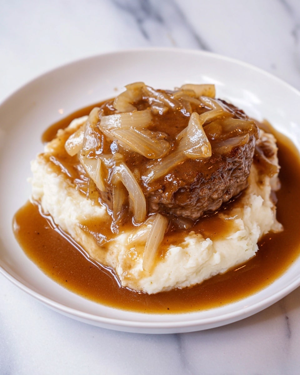The dish shows a white plate with three layers: the bottom layer is creamy mashed potatoes with a soft and fluffy texture, the middle layer is a thick, brown cooked meat patty, and the top layer consists of cooked translucent onions in a generous amount of glossy brown gravy that spreads around the plate's edges. The plate is placed on a white marbled surface. Photo taken with an iphone --ar 4:5 --v 7
