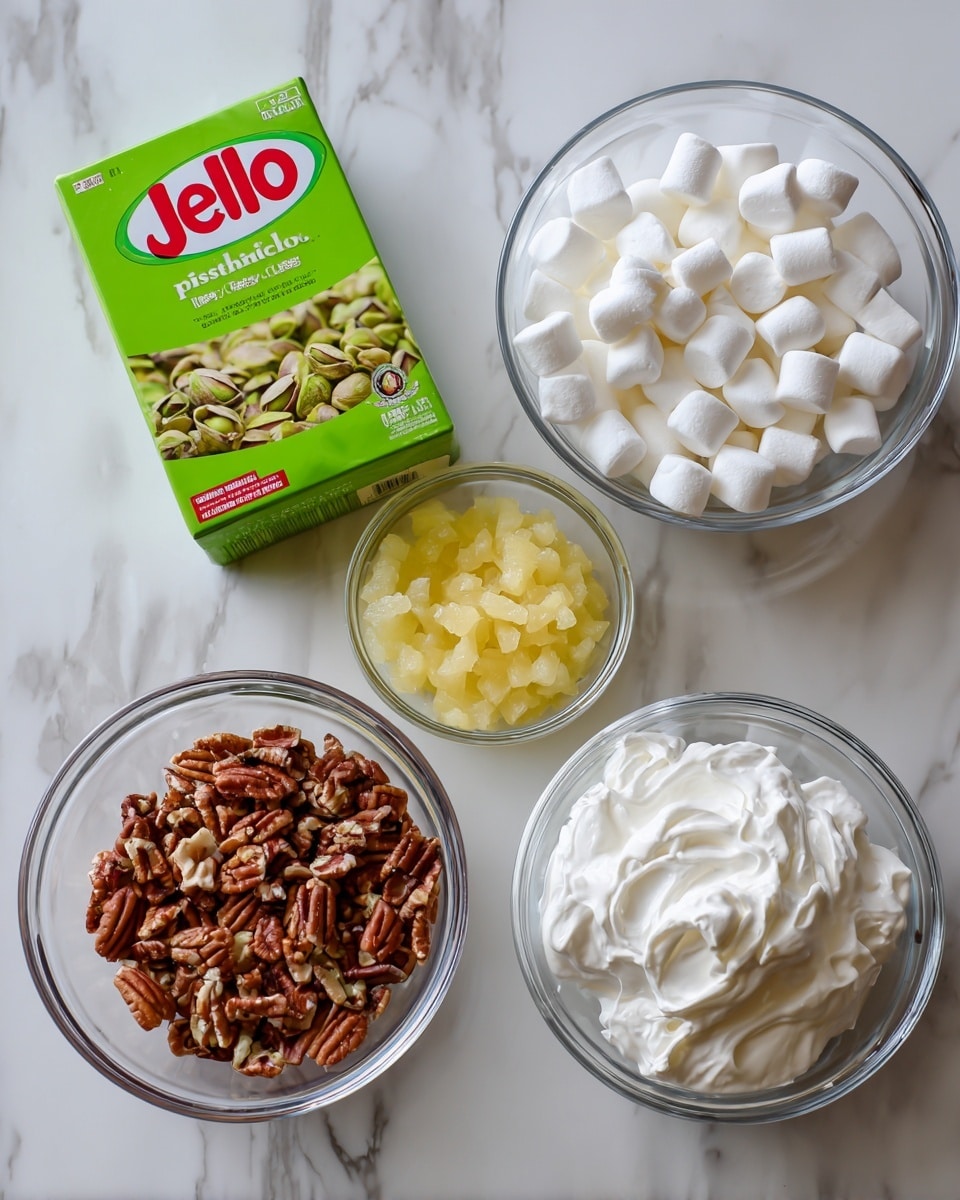The image shows five separate clear glass bowls and a box on a white marbled surface. The box at the top left is bright green with red and white writing that says