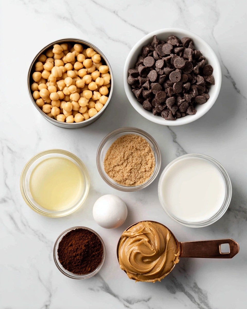 The image shows seven small containers with different ingredients placed on a white marbled surface. At the top left, there is an open tin can filled with pale yellow chickpeas. To its right, a white bowl holds dark brown chocolate chips. Below the chickpeas, there is a small glass bowl filled with light brown brown sugar that looks slightly clumpy. Next to it, a white, rounded salt shaker has a simple design. Below the brown sugar, a small white bowl contains light yellow vanilla extract, smooth in texture. To the right, another small white bowl is filled with white milk. At the bottom right, a copper measuring cup holds pale brown peanut butter, which looks thick and slightly crumbly. At the bottom left, a glass bowl contains dark brown cocoa powder with a fine texture. The containers are spaced apart on the white marbled background. photo taken with an iphone --ar 4:5 --v 7
