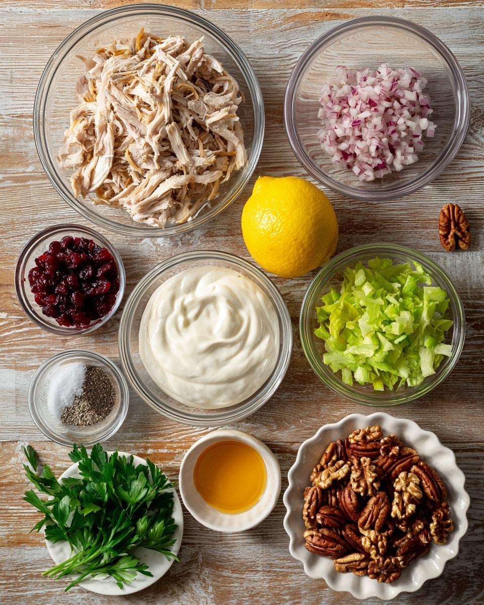 A top-down view of multiple clear bowls and a small white plate arranged neatly on a wooden surface, each containing different ingredients for a recipe. The largest bowl at the top left holds shredded light brown rotisserie chicken. To its right, a smaller clear bowl contains finely chopped pinkish shallots. Below the shallots is a clear bowl with thick white Greek yogurt, and next to it on the right, another clear bowl filled with chopped light green celery pieces. A whole bright yellow lemon is placed in the center of the arrangement. Below the lemon, there is a small white bowl with salt and black pepper side by side. Near the bottom left, a small white bowl holds golden yellow honey, next to it, a clear bowl of white mayonnaise with a creamy texture. To the bottom right corner, a clear bowl contains roughly chopped dark brown pecans, and next to it, a small white scalloped plate holds fresh bright green parsley leaves. At the top left corner below the chicken is a clear bowl with deep red dried cranberries. The whole setup is laid on a white marbled texture surface. photo taken with an iphone --ar 4:5 --v 7