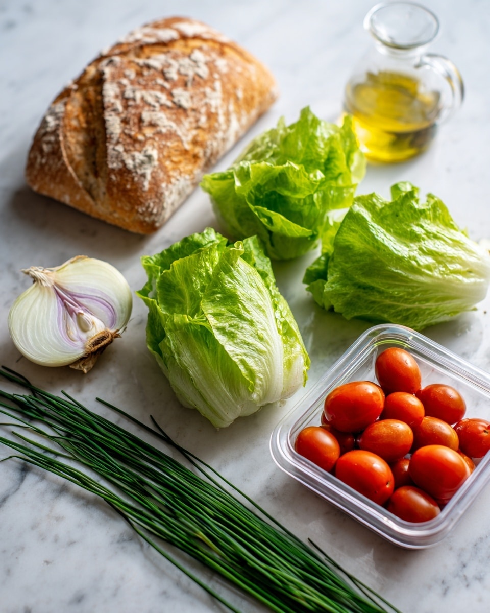 The image shows three small heads of baby gem lettuce, bright green and fresh, placed on a white marbled surface near a small loaf of golden brown bread with a crusty texture. Next to the bread, there is one half of a shallot with pale purple skin and white inside. Below them, a small glass container holds golden olive oil and a clear plastic container is full of shiny red cherry tomatoes. In front of all, a bunch of long green chives lies horizontally on the white marbled surface. photo taken with an iphone --ar 4:5 --v 7