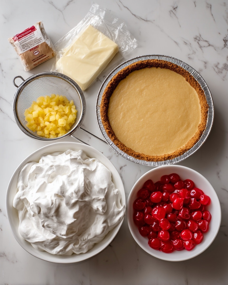 The image shows ingredients for a dessert laid out on a white marbled surface arranged neatly. On the top right is a 9-inch graham crust in a foil pan, golden brown and smooth. Next to it on the left is an unwrapped 8 oz cream cheese bar, white and soft-looking. In the center is a small sieve filled with crushed yellow pineapple, with some juice dripped below. To the right of the sieve is a small brown paper packet labeled pudding mix. At the bottom left is a white bowl filled with 8 oz of white whipped topping, fluffy in texture. To the bottom right is a white bowl filled with bright red maraschino cherries, shiny and round. Photo taken with an iphone --ar 4:5 --v 7