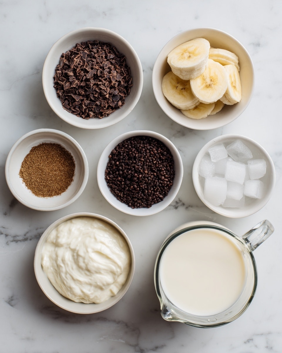 The image shows a clean white marbled surface with eight small white bowls and a glass jug arranged neatly. One bowl contains dark brown cocoa nibs, another has a stack of pale yellow frozen banana slices. There is a bowl with smooth white yogurt, a smaller bowl filled with tiny dark brown instant coffee granules, and a bowl holding a fine brown espresso powder. A tiny bowl with light brown cardamom powder is placed nearby, next to a bowl of white ice cubes. The large glass jug is filled with creamy white milk, positioned at the bottom right. Each item is clearly visible with distinct colors and textures, all set on the white marbled background. photo taken with an iphone --ar 4:5 --v 7