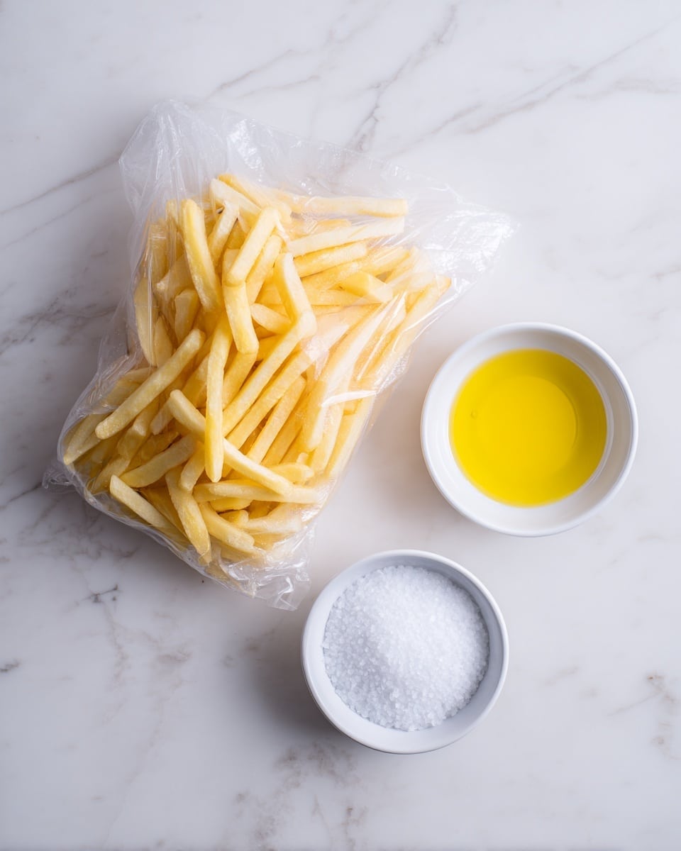 The image shows a clear plastic bag filled with frozen French fries placed on a white marbled surface. Next to the bag, there are two small white bowls; one contains yellow oil with a smooth, shiny texture, and the other holds white salt with a fine, grainy look. The arrangement is simple and clean, with all items positioned close together. Photo taken with an iphone --ar 4:5 --v 7