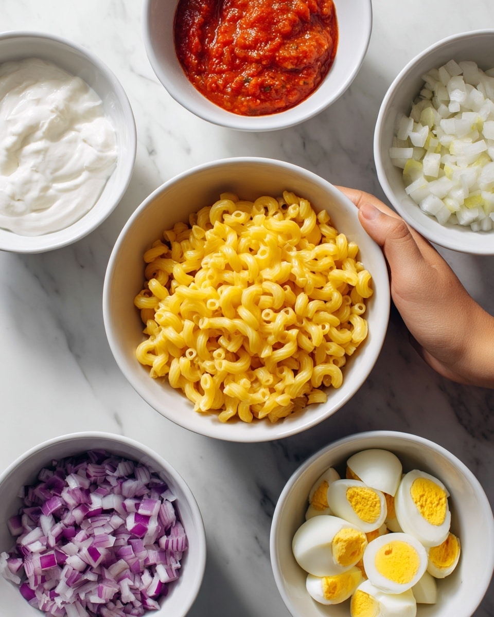 The image shows five white bowls on a white marbled surface. The largest bowl in the center contains yellow macaroni pasta. Around it, there are four smaller bowls: one with thick white sour cream or yogurt, one with bright red salsa, one with finely chopped purple onions, and one with chopped boiled eggs that have yellow yolks and white edges. A woman's hand is holding the bowl of chopped eggs. The bowls are arranged neatly with the colors contrasting clearly against the white bowls and surface. photo taken with an iphone --ar 4:5 --v 7
