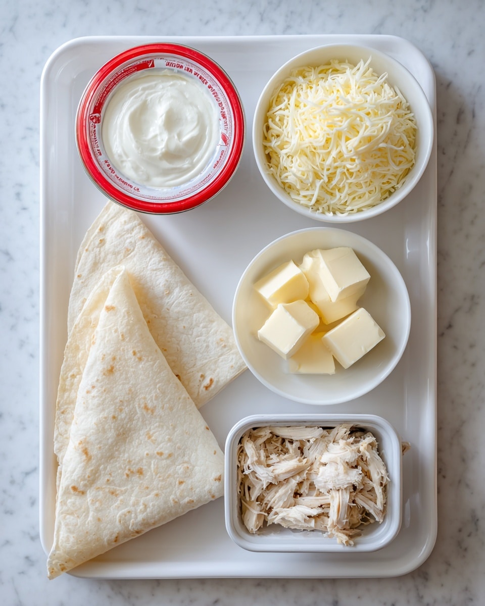 A white rectangular tray holds several ingredients neatly arranged: two folded tortillas on the left side, a round container of sour cream with a red and white lid near the top left, a small white bowl filled with shredded cheese next to it, and another small white bowl with three cubes of butter in the center. Below the butter is a small pile of shredded cooked chicken in a white dish. To the right, there are two stacked cans. The entire scene is set on a white marbled surface. photo taken with an iphone --ar 4:5 --v 7
