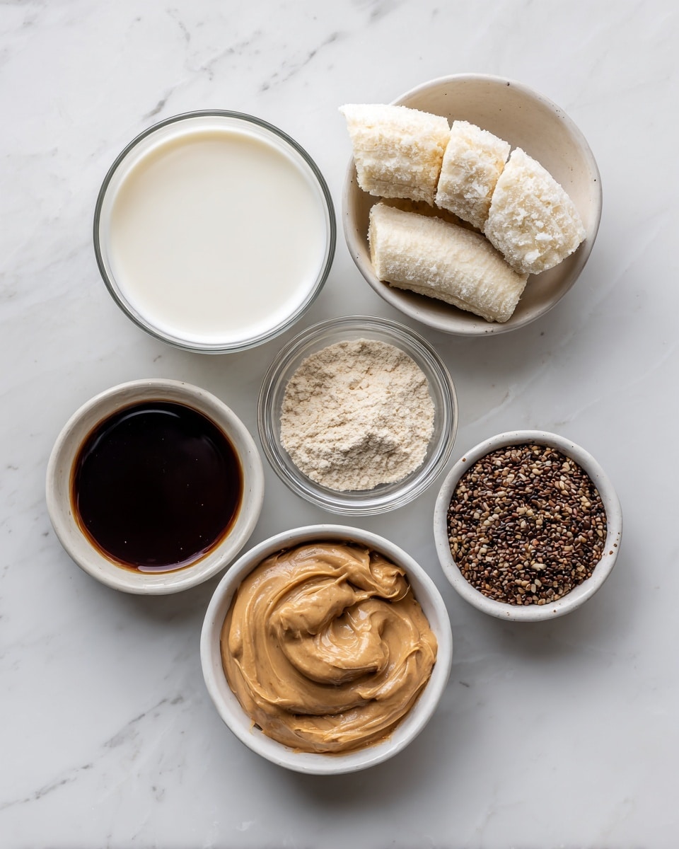 The image shows six small white bowls placed on a white marbled surface. The top left bowl is filled with white milk, the top right bowl holds two frozen banana halves covered in frost. Below the milk bowl is a small glass bowl containing light beige protein powder. In the middle, slightly to the right, is a bowl filled with dark brown coffee. Below the coffee is a bowl with smooth peanut butter, creamy and light brown in color. The bottom right bowl contains dark vanilla extract inside. Next to the vanilla is a small bowl with ground flex seeds, brown and finely ground. All bowls have a simple, clean look. Photo taken with an iphone --ar 4:5 --v 7