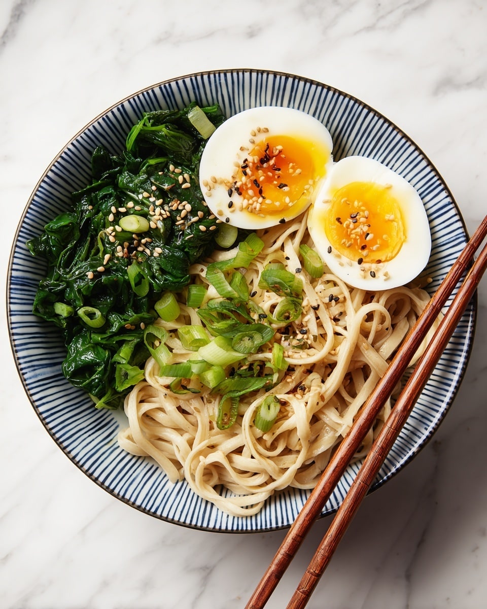 A white bowl with blue vertical stripes holds three main layers: on the left side are bright green cooked leafy vegetables with a light spinach texture; next to them are two halves of a soft-boiled egg with firm white and slightly runny yellow yolk, sprinkled with sesame seeds; the biggest layer on the right consists of light brown wide noodles mixed with chopped green onions and sesame seeds. A pair of wooden chopsticks holds some noodles at the bottom center of the bowl. The bowl sits on a white marbled surface. Photo taken with an iphone --ar 4:5 --v 7