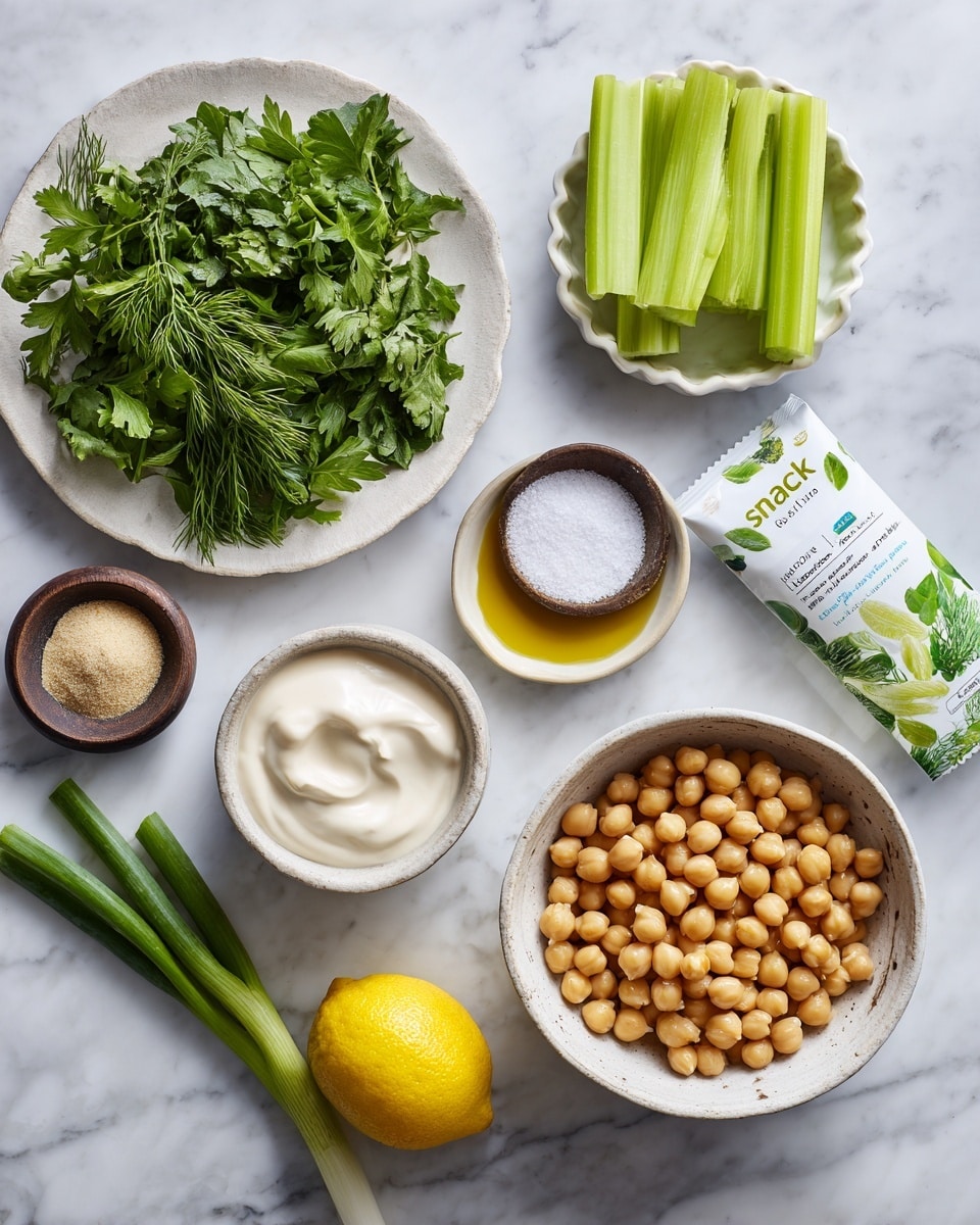A white marbled surface holds an arrangement of fresh ingredients: a white plate filled with green leafy parsley and dill on the top left, a small white scalloped bowl with salt above center, and a pack of celery sticks with bright green celery visible through clear packaging marked