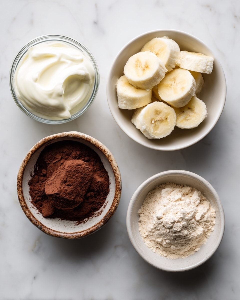 The image shows four small bowls arranged on a white marbled surface. The top right bowl is white and holds several pieces of frozen bananas, which are pale yellow with a frosty texture. Below it to the left, a small clear glass bowl contains smooth, thick white Greek yogurt. To the right of the yogurt, another white bowl is filled with light beige protein powder that looks fine and powdery. At the bottom left, a rustic light brown bowl holds dark brown cocoa powder with a soft, dusty texture, marked optional. All bowls have clear, simple shapes with the frozen bananas and cocoa bowl having a slightly rougher look from their contents. photo taken with an iphone --ar 4:5 --v 7