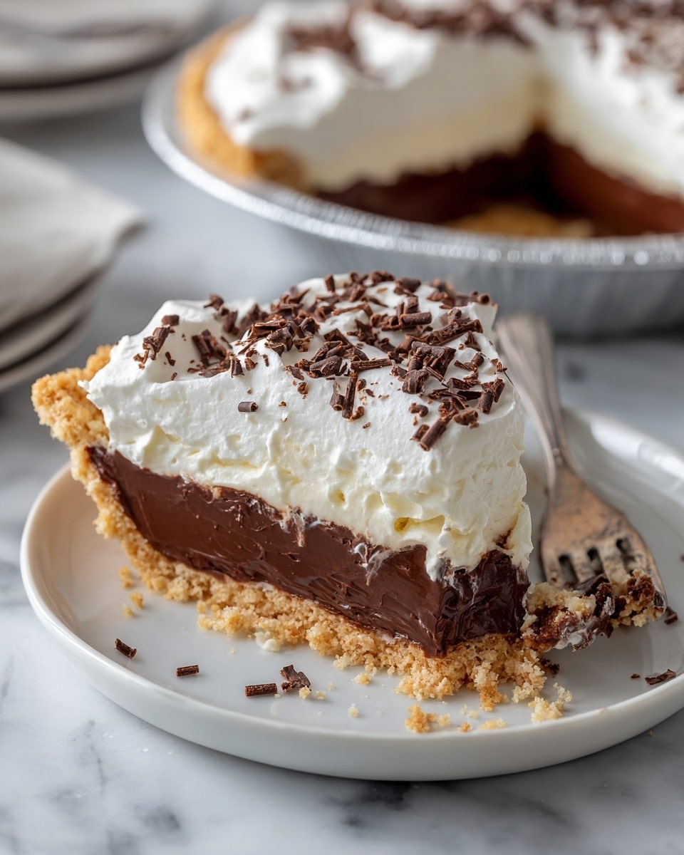 The image shows a slice of pie with three visible layers on a white plate. The bottom layer is a light brown crust with a crumbly texture. Above it is a thick dark chocolate layer that looks smooth and dense. The top layer is a fluffy white cream with small chocolate shavings sprinkled over it. Next to the slice on the plate is a silver fork holding a bite-sized piece of the pie, showing all three layers clearly. The background is a white marbled surface with the rest of the pie in a foil pan blurred in the distance. photo taken with an iphone --ar 4:5 --v 7