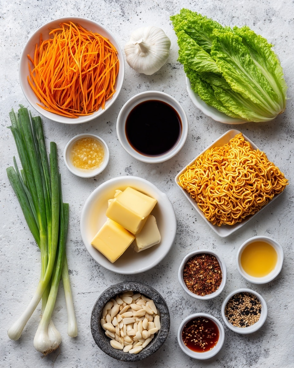 The image shows various fresh and packaged ingredients arranged neatly on a white marbled surface. At the upper left is a white bowl filled with thin, bright orange carrot sticks, and to its right is a half head of green leafy lettuce showing light green veins. Below the carrots, there is a small white bowl filled with dark soy sauce, and below it a white bowl holding two small yellow butter blocks with a soft texture. Next to the butter is a white bowl with sliced light brown almonds. Near the bottom left corner are two green onions with long green stalks and white bulbs. In the middle-right area are two bright orange and yellow packets of chicken-flavored ramen noodles packets. Scattered around the lower part are small white bowls holding different sauces and ingredients in various colors: light yellow, pale yellow, dark red, brown, and white sesame seeds. Near the center bottom is a whole white garlic bulb. On the gray marbled surface near the center is a small stone bowl filled with mixed whole peppercorns of different shades. The whole setup is colorful, fresh, and ready for cooking. Photo taken with an iphone --ar 4:5 --v 7