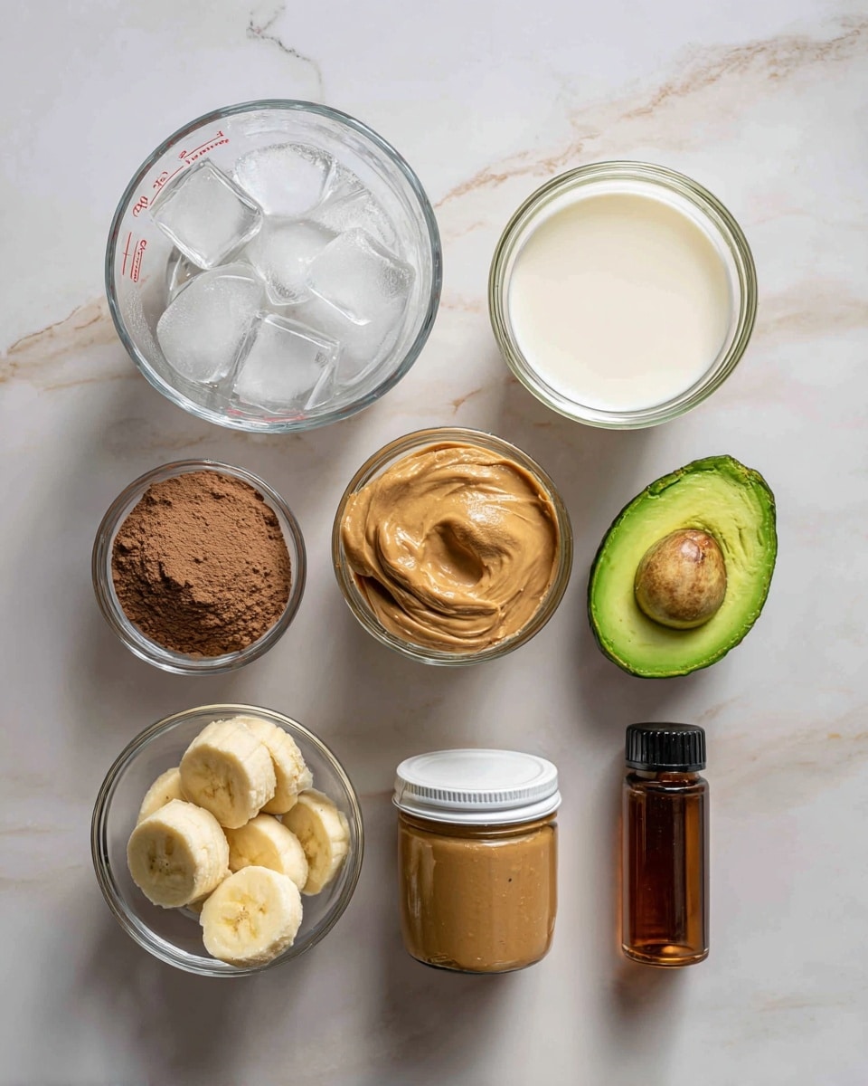 The image shows seven ingredients laid out on a white marbled surface. At the top left, there is a clear glass measuring cup filled with ice cubes, next to it on the right is another clear glass measuring cup filled with creamy white coconut milk. Below the ice cup is a small clear round container with light brown chocolate protein powder. To the right of that is a halved avocado with green flesh. At the bottom left, there is a small clear bowl holding three peeled banana pieces. Next to the bowl, a jar of creamy peanut butter with a white lid sits in the center. On the bottom right, a small amber bottle of vanilla extract with a black lid completes the arrangement. All items are neatly spaced and clearly labeled with text above or below them, photo taken with an iphone --ar 4:5 --v 7