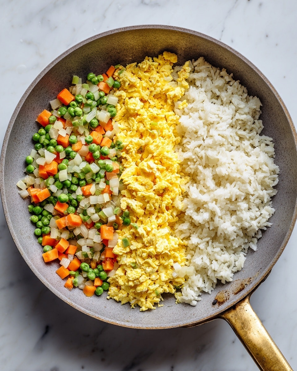 A round gray pan with a golden handle shows three clear layers side by side inside it on a white marbled surface. On the right side is a heap of fluffy white rice with a soft texture. Next to the rice, in the middle, is a bright yellow layer of scrambled eggs with a slightly crumbly texture. On the left side, there is a mix of small green peas, orange carrot cubes, and bits of white onion, giving a colorful and fresh look. The colors are vibrant against the gray of the pan and the marbled white background photo taken with an iphone --ar 4:5 --v 7