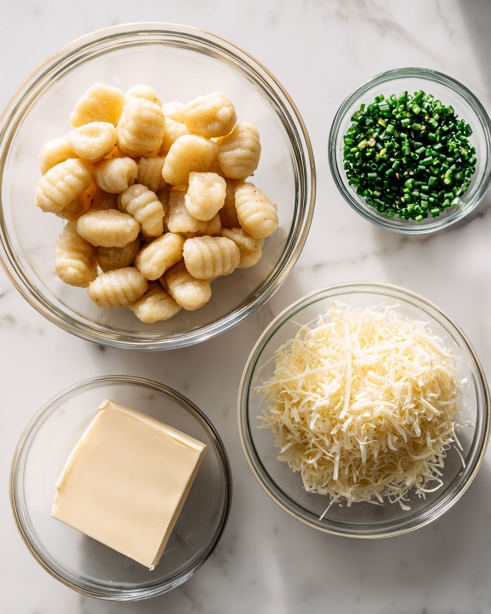 A clear glass bowl filled with light beige, pillowy gnocchi sits on a white marbled surface in the top left area. To the right, a small clear glass bowl holds finely chopped dark green chives. Below that, another clear glass bowl is filled with pale creamy yellow grated parmesan cheese, showing a fluffy texture. At the bottom left, a small clear glass bowl contains a square piece of off-white unsalted butter. Each ingredient is spaced apart on the white marbled surface, with bright, natural lighting highlighting their colors and textures. Photo taken with an iphone --ar 4:5 --v 7