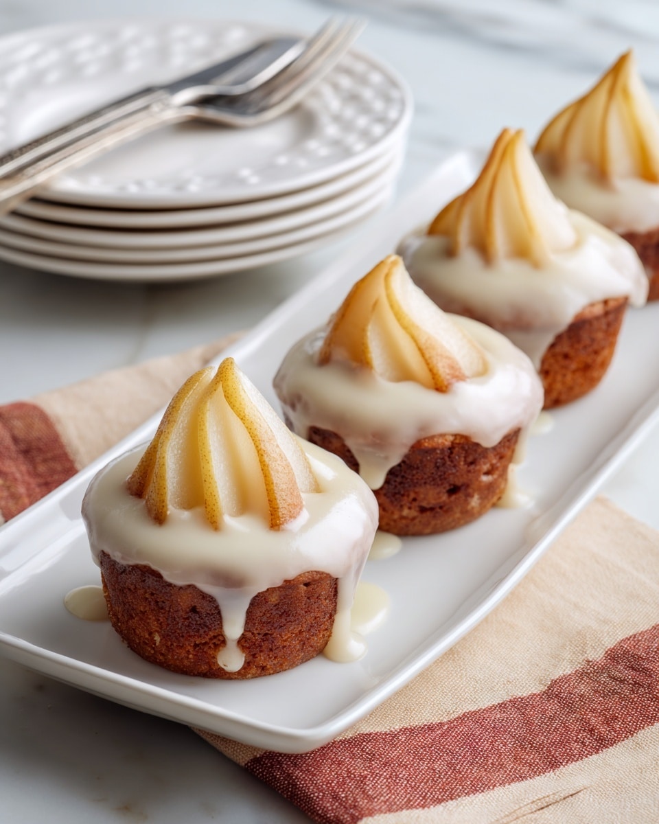 The image shows small muffins placed on a metal cooling rack over a white marbled surface. Each muffin has a golden-brown base with a soft, slightly cracked top layer featuring swirls of cinnamon that create darker brown lines. On top of each muffin, there is a shiny layer of glossy, cooked apple slices arranged to show their slightly translucent, pale yellow color with a light glaze that makes them glisten in the light. The muffins are close together, and the focus is on the one in the foreground, showing detailed texture and warm tones. Photo taken with an iphone --ar 4:5 --v 7